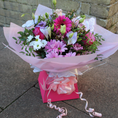 Ashleigh - A budding delight, complimented by greenery and presented in a gift box/bag. Beautiful flower bouquet hand delivered by the local florist.
